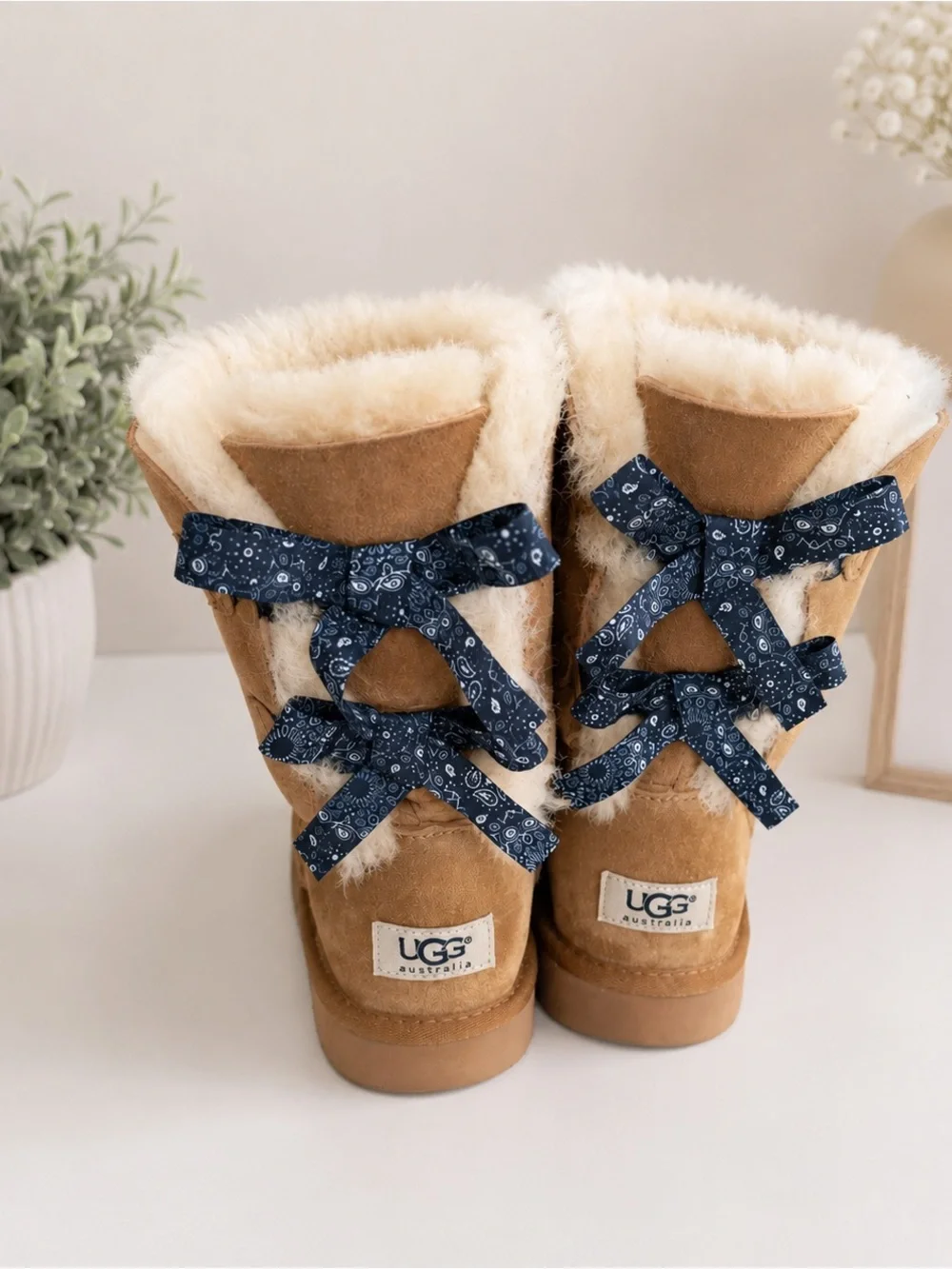 UGG Kids Tan Shearling Boots with Navy Bow Accents